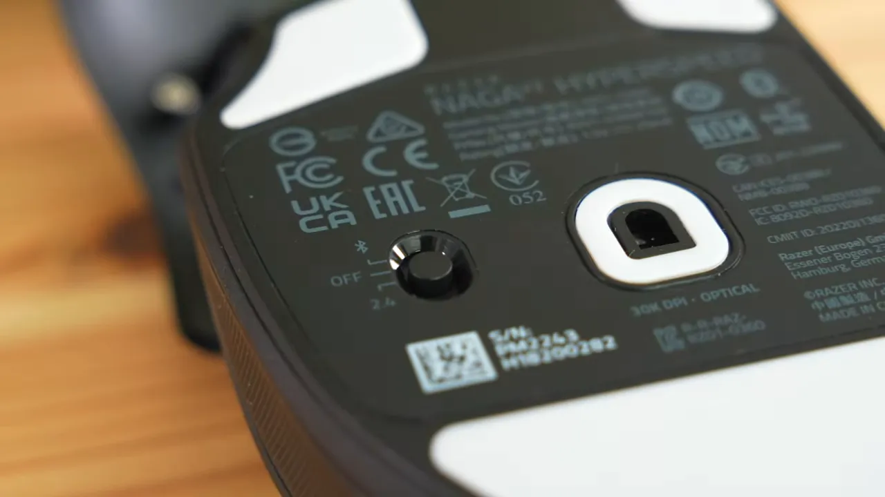 Clear close-up of the bottom of the Razer Naga V2 mouse showing the mode switch labeled Off, Bluetooth and 2.4