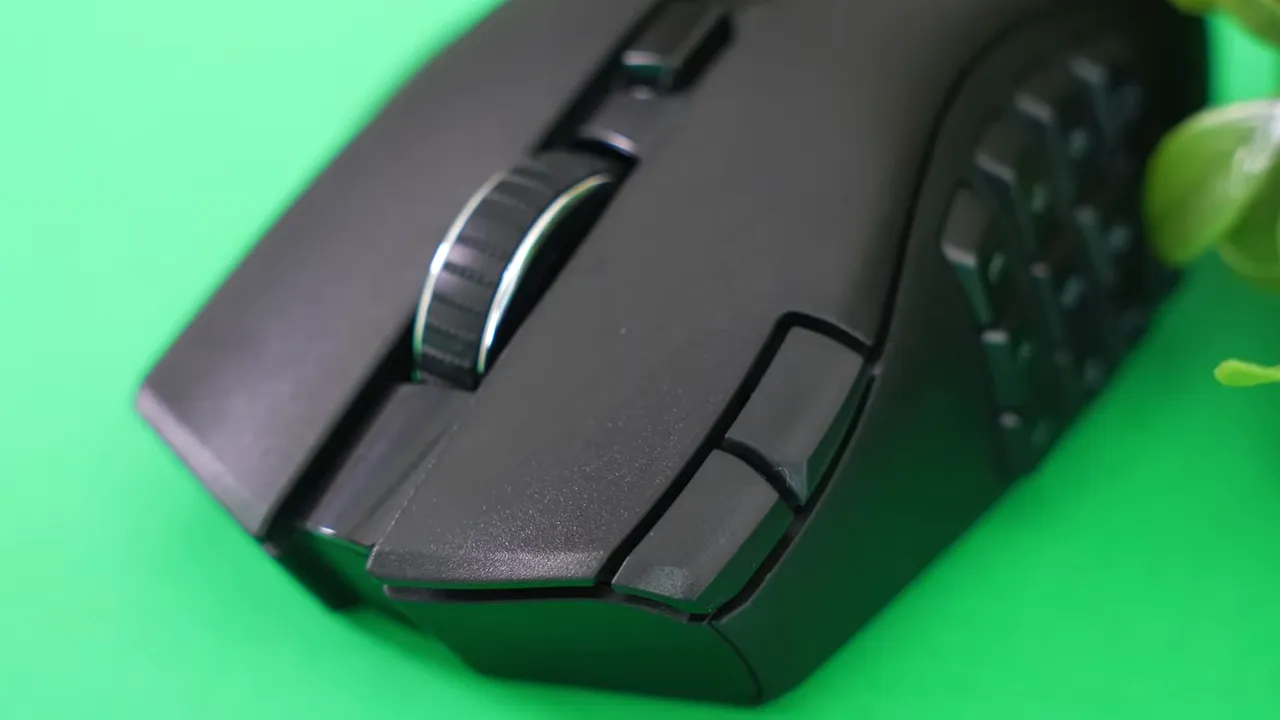 Close-up of Razer Naga V2 showing the scroll wheel and two corner buttons beside the primary click