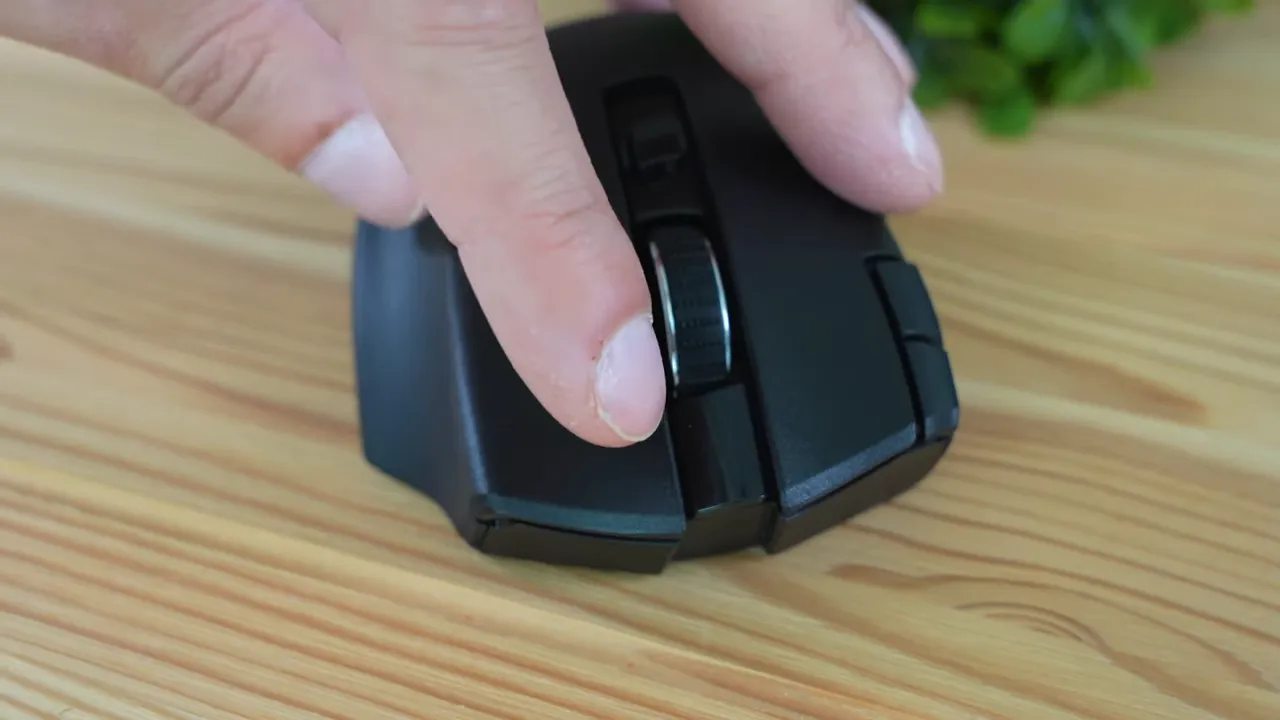 Finger pressing the scroll wheel and left-click area on the Razer Naga V2 to demonstrate click feel