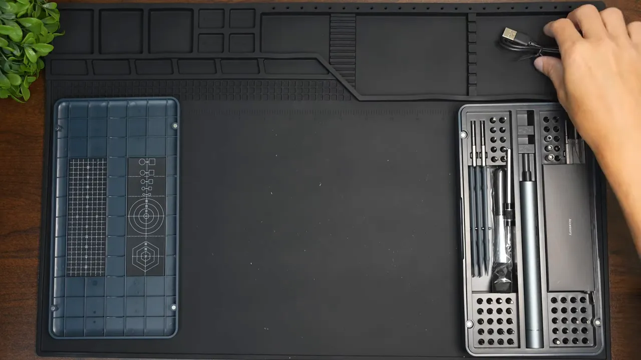 full layout of iFu 90-in-1 screwdriver kit with USB-C charging cable on mat