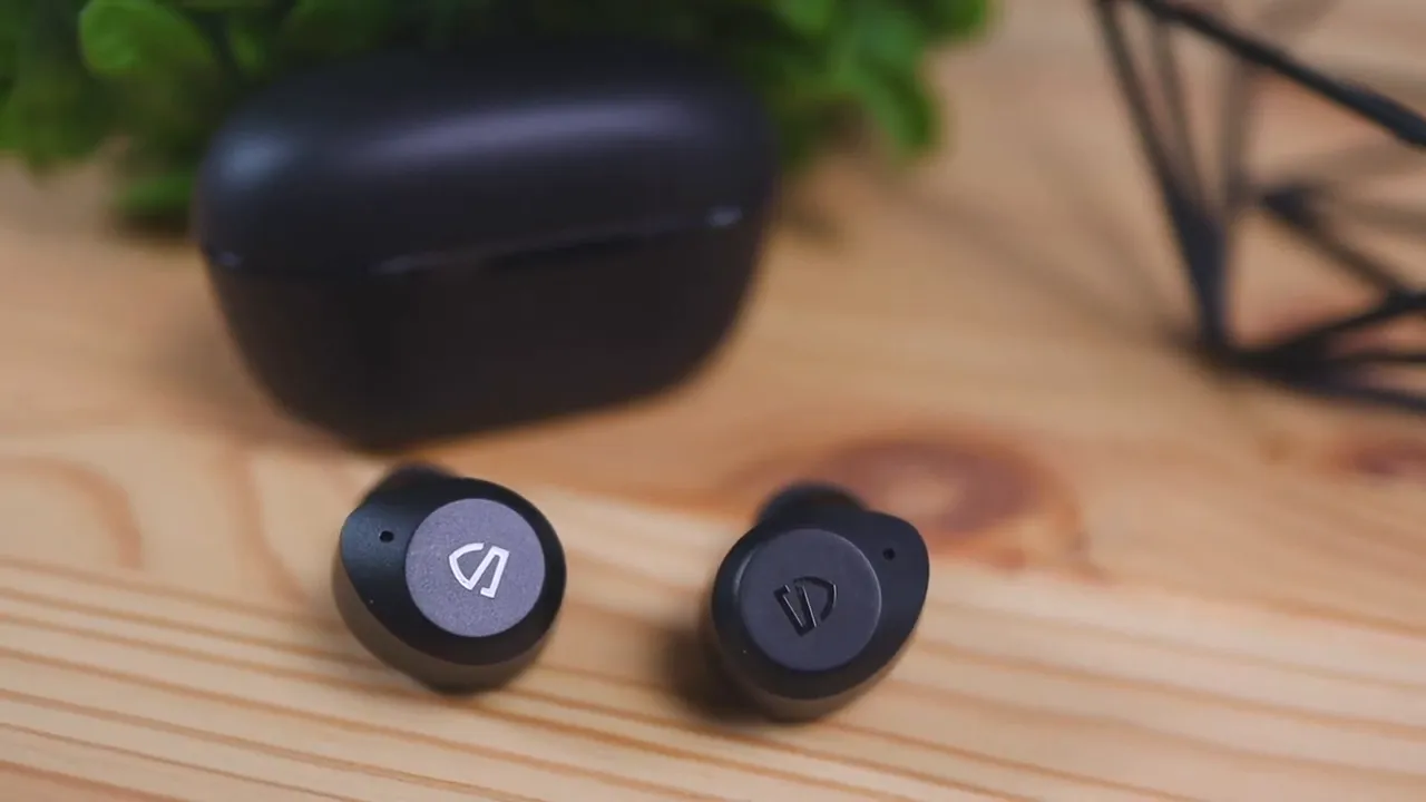 SoundPEATS T2 earbuds with charging case blurred in background