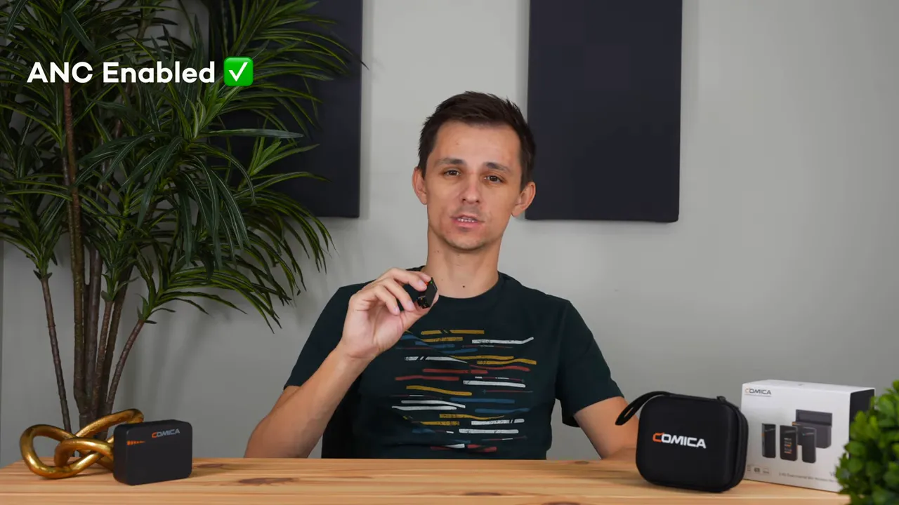 Presenter holding a Comica Vimo C3 transmitter with on-screen text 'ANC Enabled' and a green check mark.