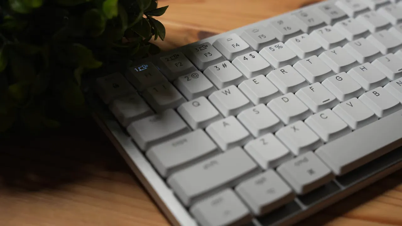MX Mechanical MINI keyboard with proximity backlight indicator illuminated near the top-left keys.