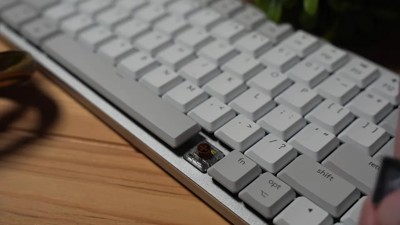 Detailed view of tactile mechanical switch on Logitech MX Mechanical MINI with surrounding keycaps