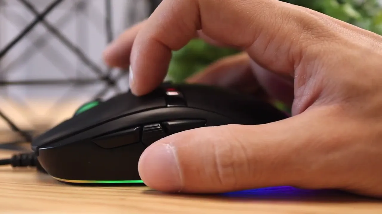 Close side view of hand pressing buttons near the side controls of the mouse