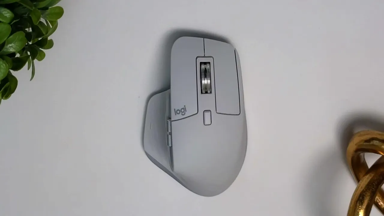 Close top-down view of a Logitech MX Master 3s highlighting the machined steel MagSpeed scroll wheel and button layout.