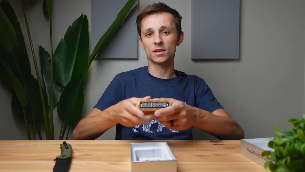 Starship Seer power bank held up showing the front display and transparent yellow shell