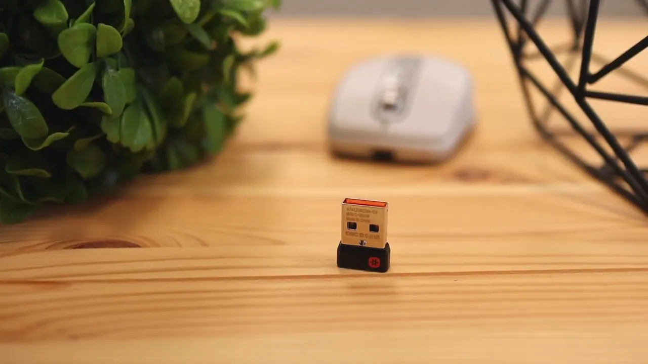 Mouse in use with USB-C charging cable connected at the front