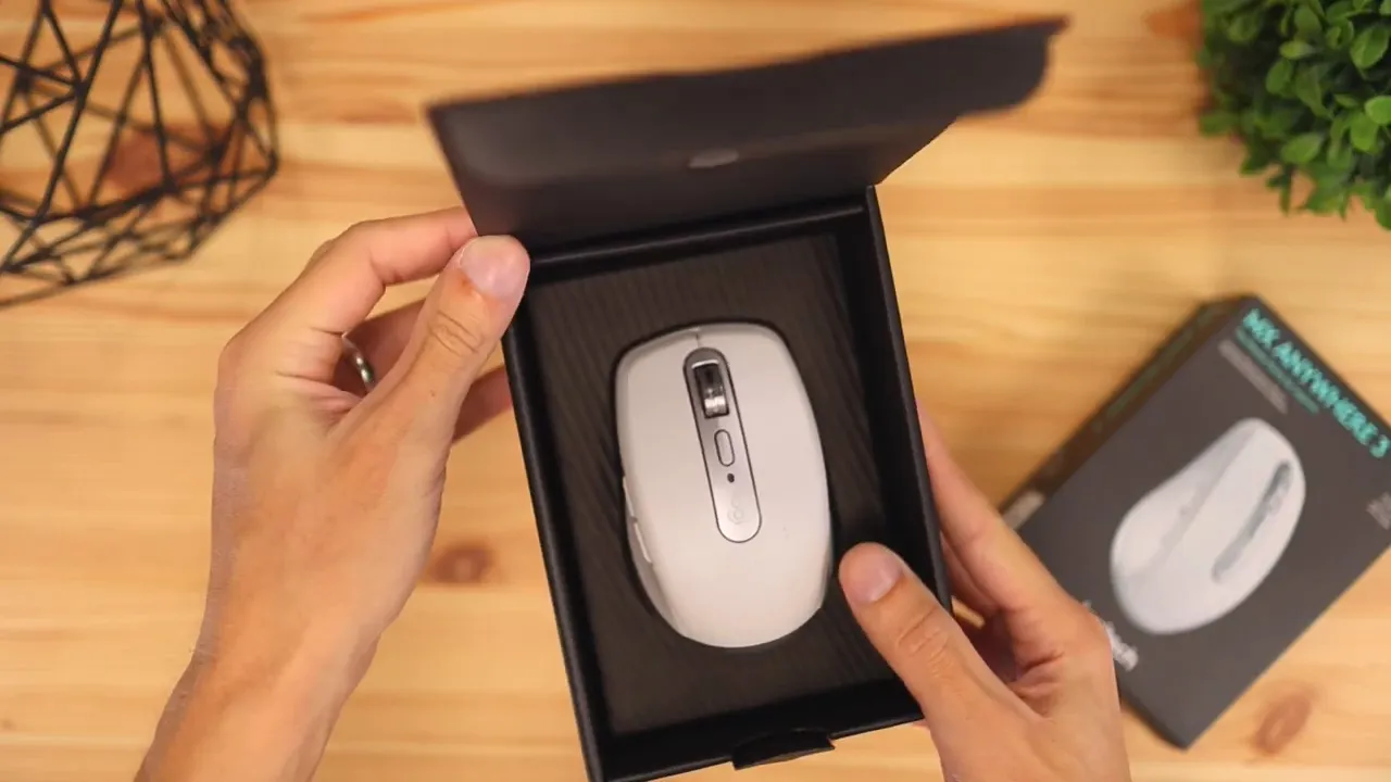 Open product box showing the mouse seated inside packaging