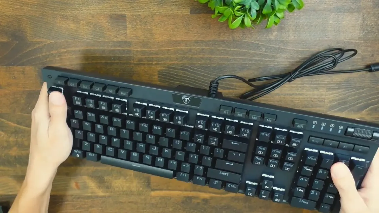Top-down shot of Risophy full-size keyboard on wooden desk with macro keys and USB cable visible