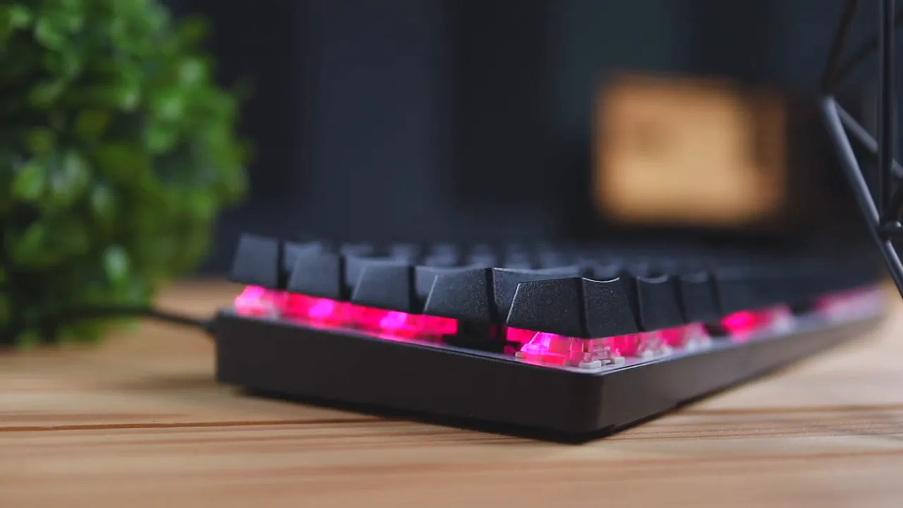 Whirlwind FX Atom 60% keyboard side view with red RGB underglow and shine-through keycaps