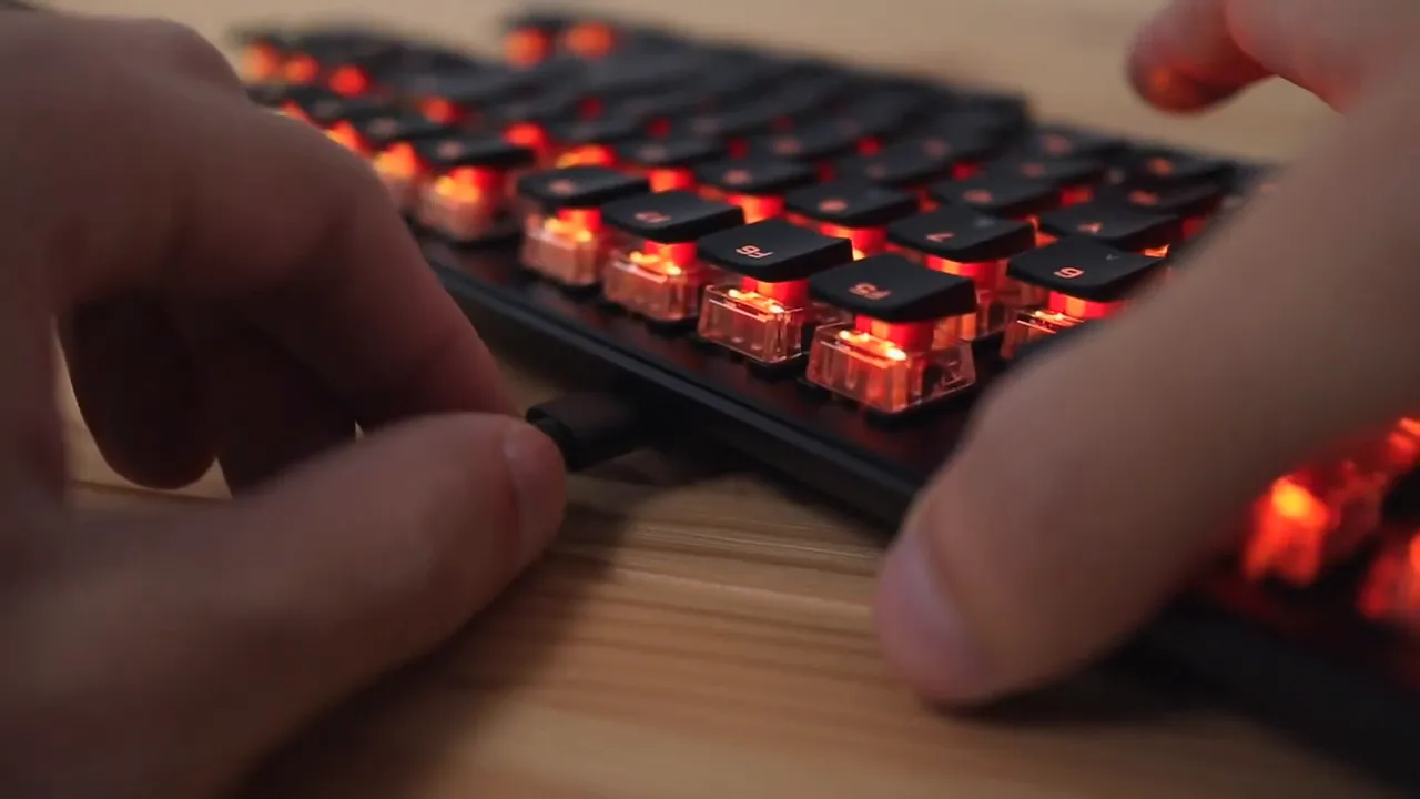 USB C cable plugged into the side of the keyboard