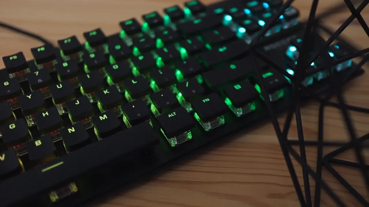 Top right area of keyboard showing media keys, volume knob, and brushed metal plate