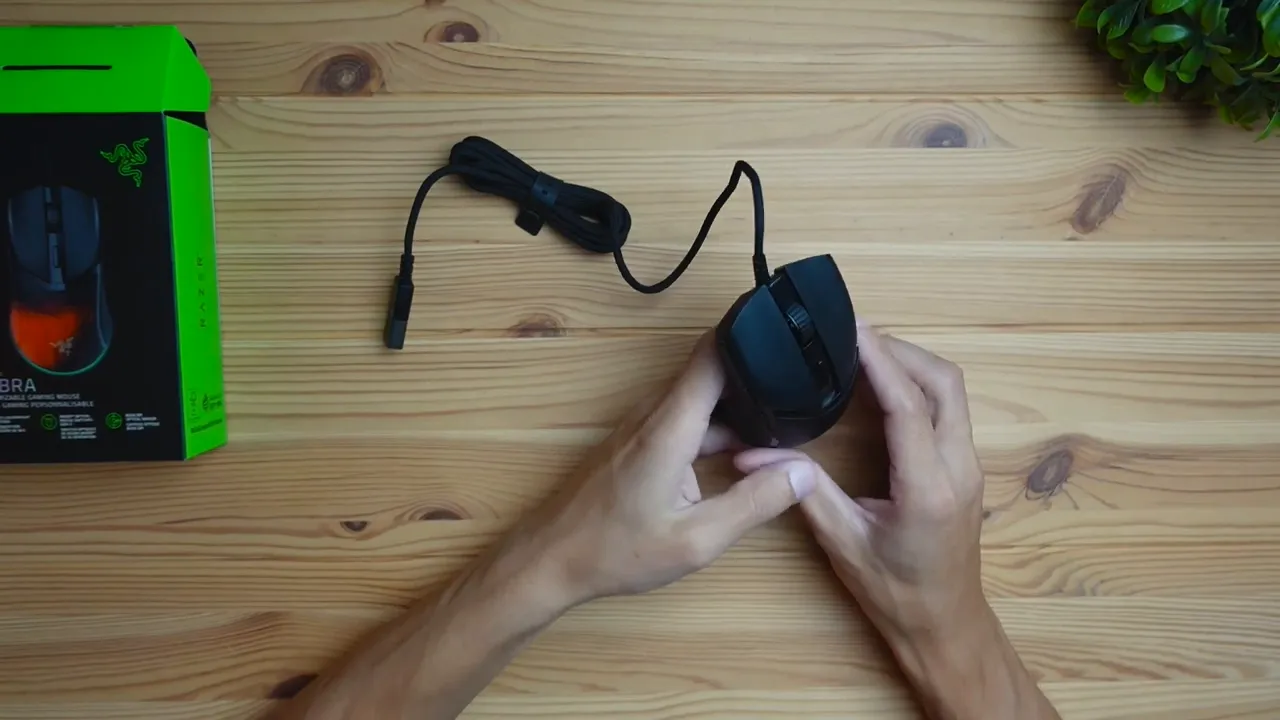 Top-down shot of Razer Cobra mouse showing scroll wheel, textured sides, braided cable and box