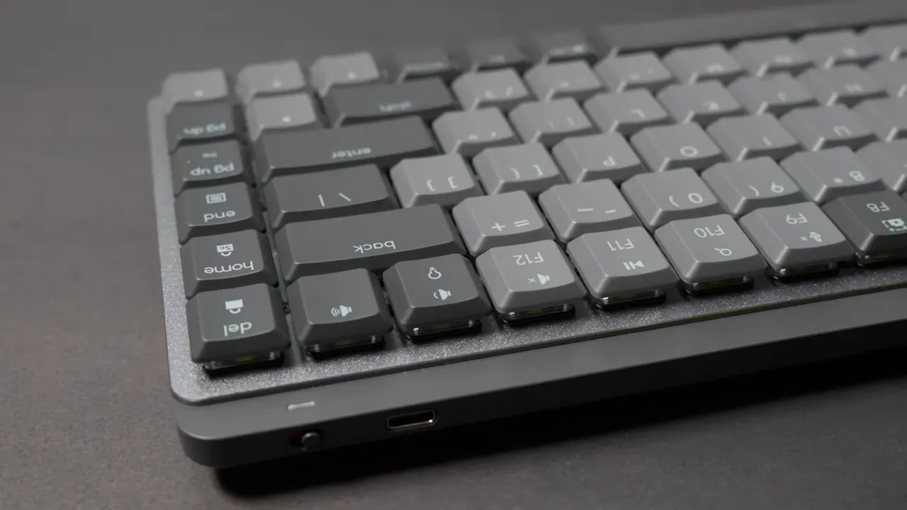 Logitech MX Mechanical Mini close-up showing textured aluminum top, keycaps, and USB-C port