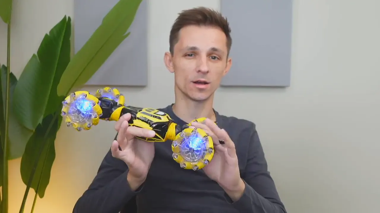 Person holding the DoDoeleph RC car with bright blue LED-lit wheels visible, showing the whole vehicle