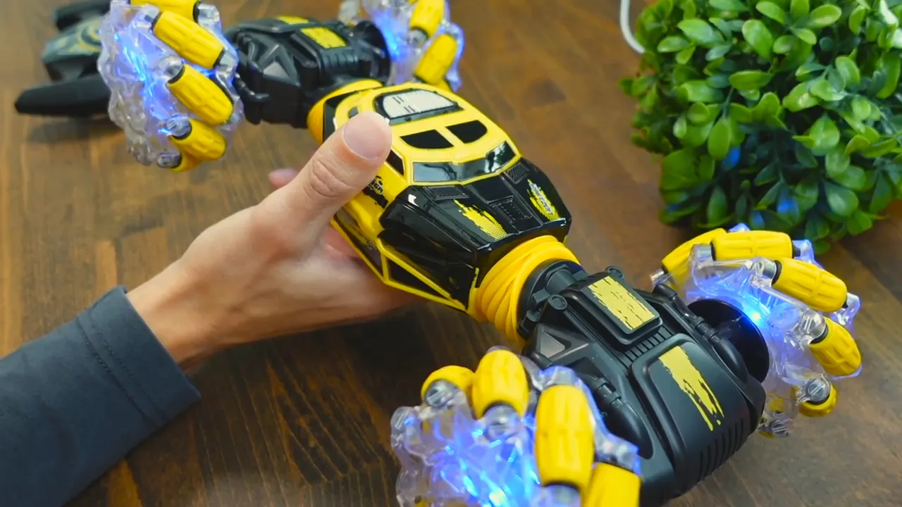 Close-up of the DoDoeleph RC car held in hand showing the central chassis, posture area, and illuminated mecanum-style wheels.