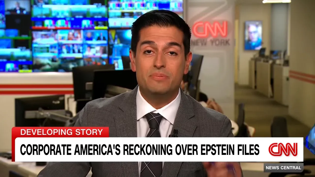 High-quality television still of a news correspondent in a newsroom with a visible chyron reading 