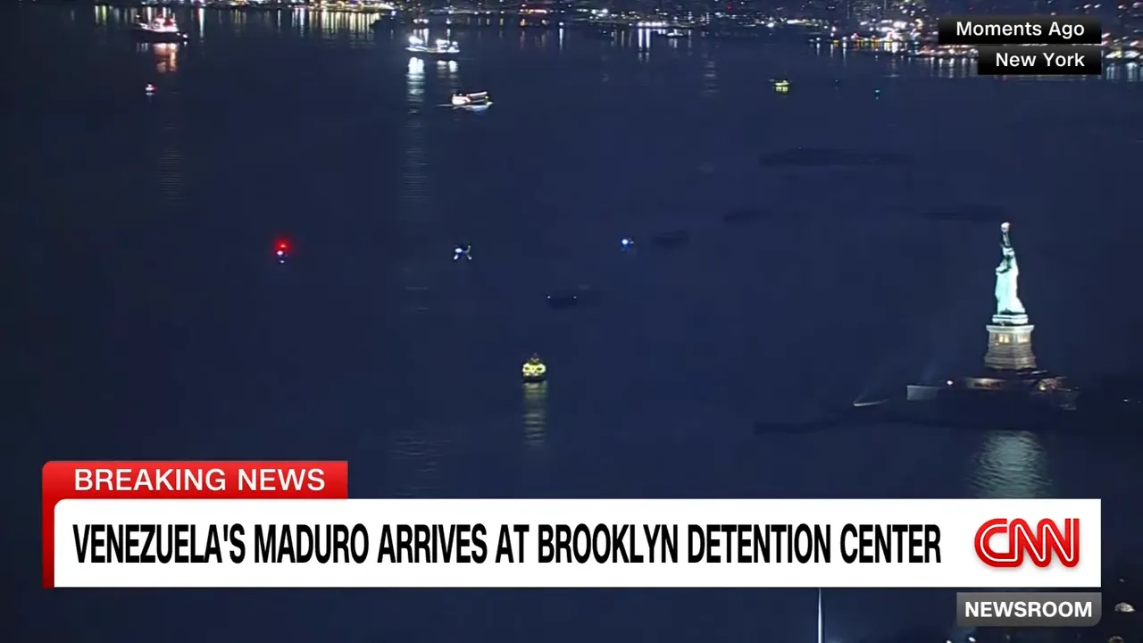 Clear night aerial view of New York Harbor with the Statue of Liberty visible and CNN breaking-news banner: 