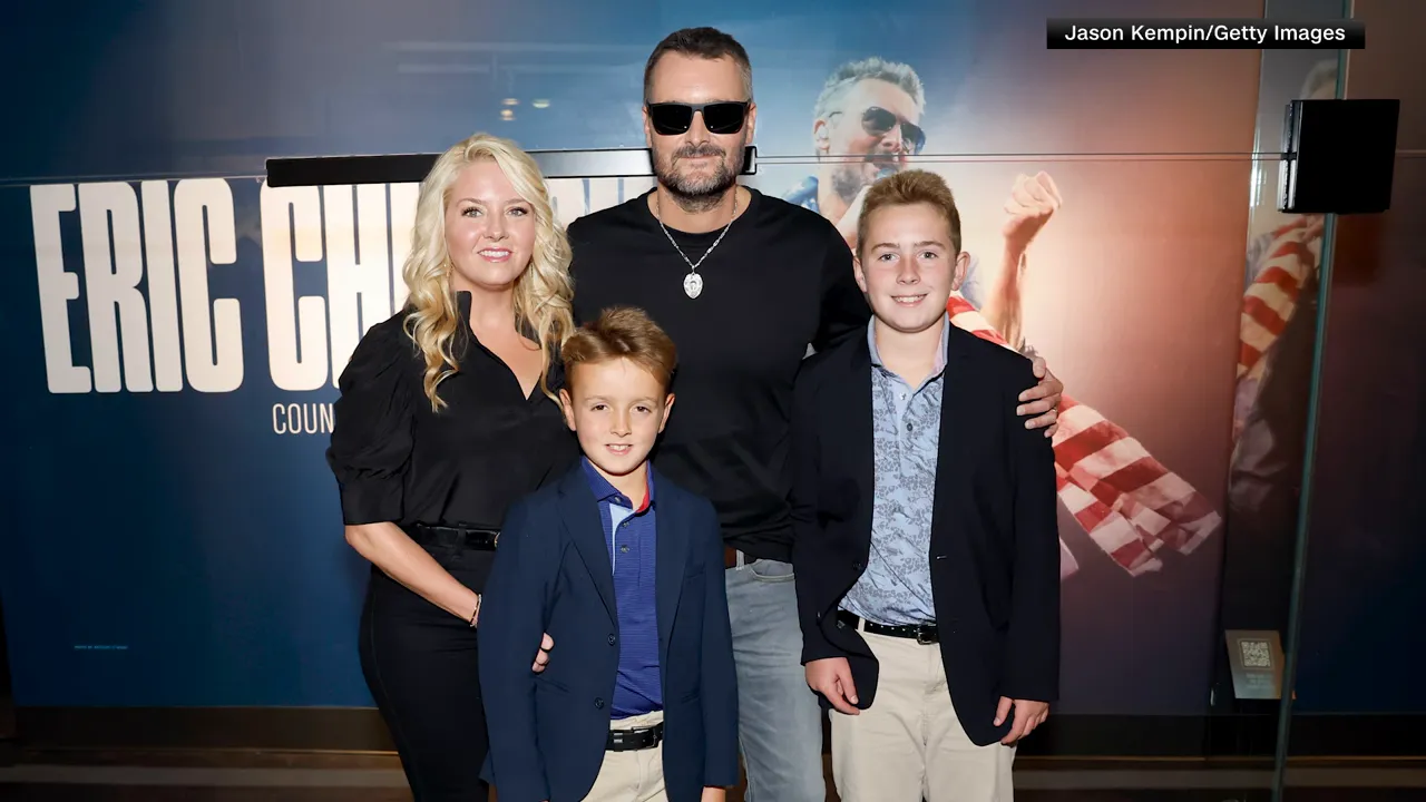 Country musician posing with his partner and two sons at a public event