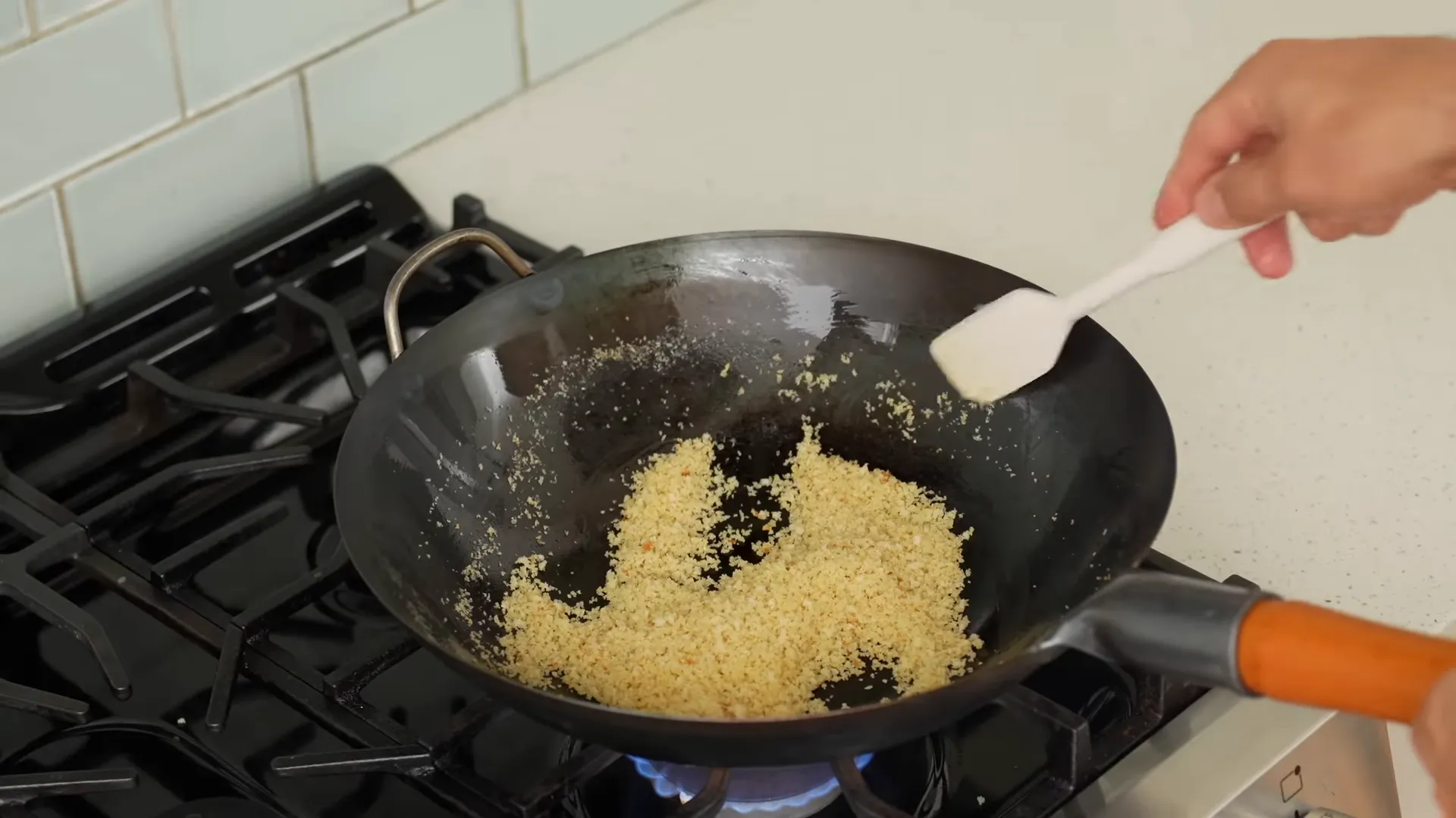 Toasting panko breadcrumbs in the wok until golden