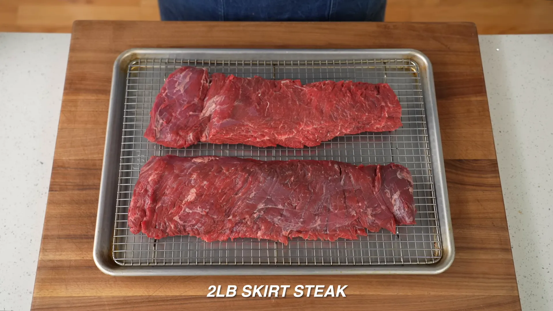 Two pounds of skirt steak on a cutting board, about an inch thick