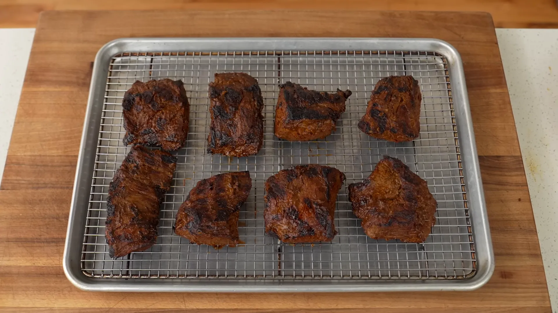 Grilled skirt steak with dark char marks ready to rest