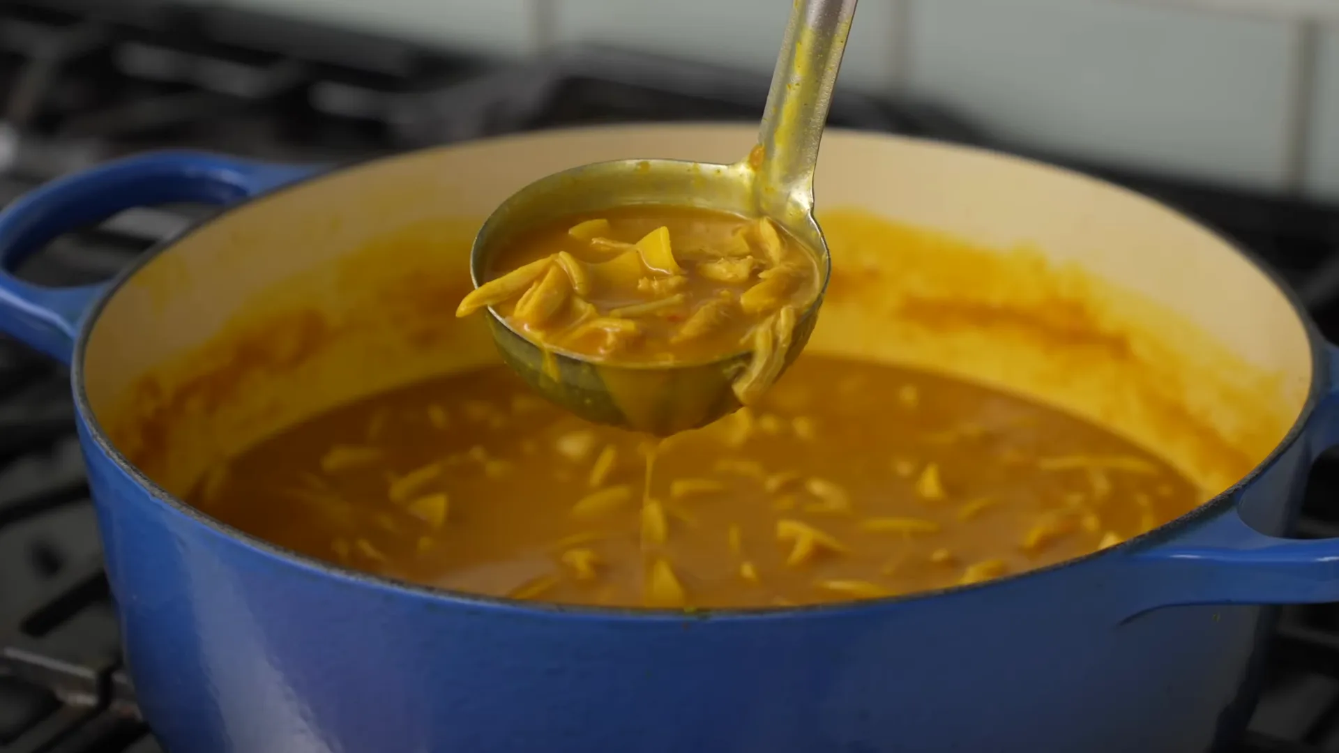 Shredded chicken returned to the rich coconut broth