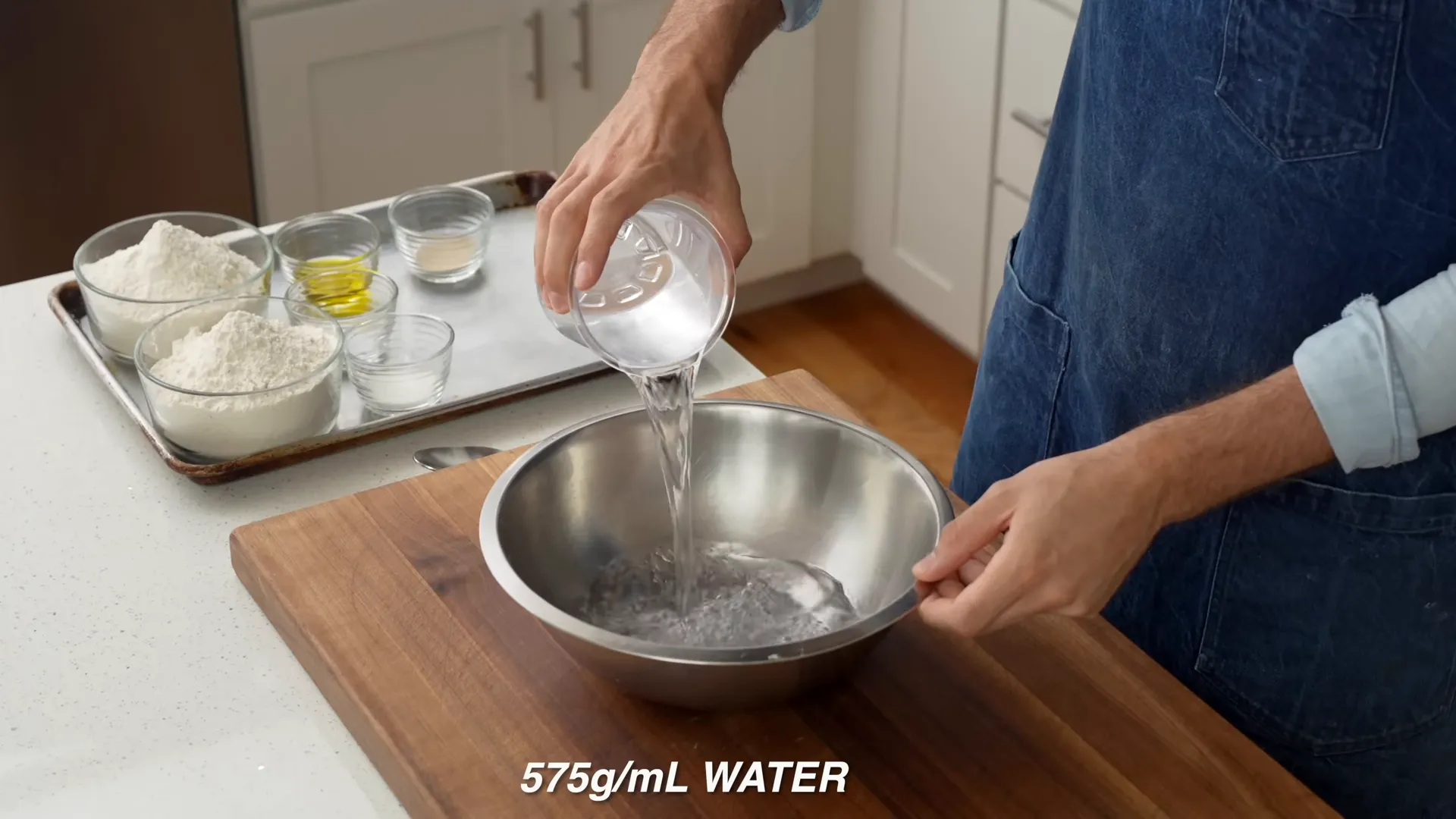 Me measuring water and adding yeast to a bowl