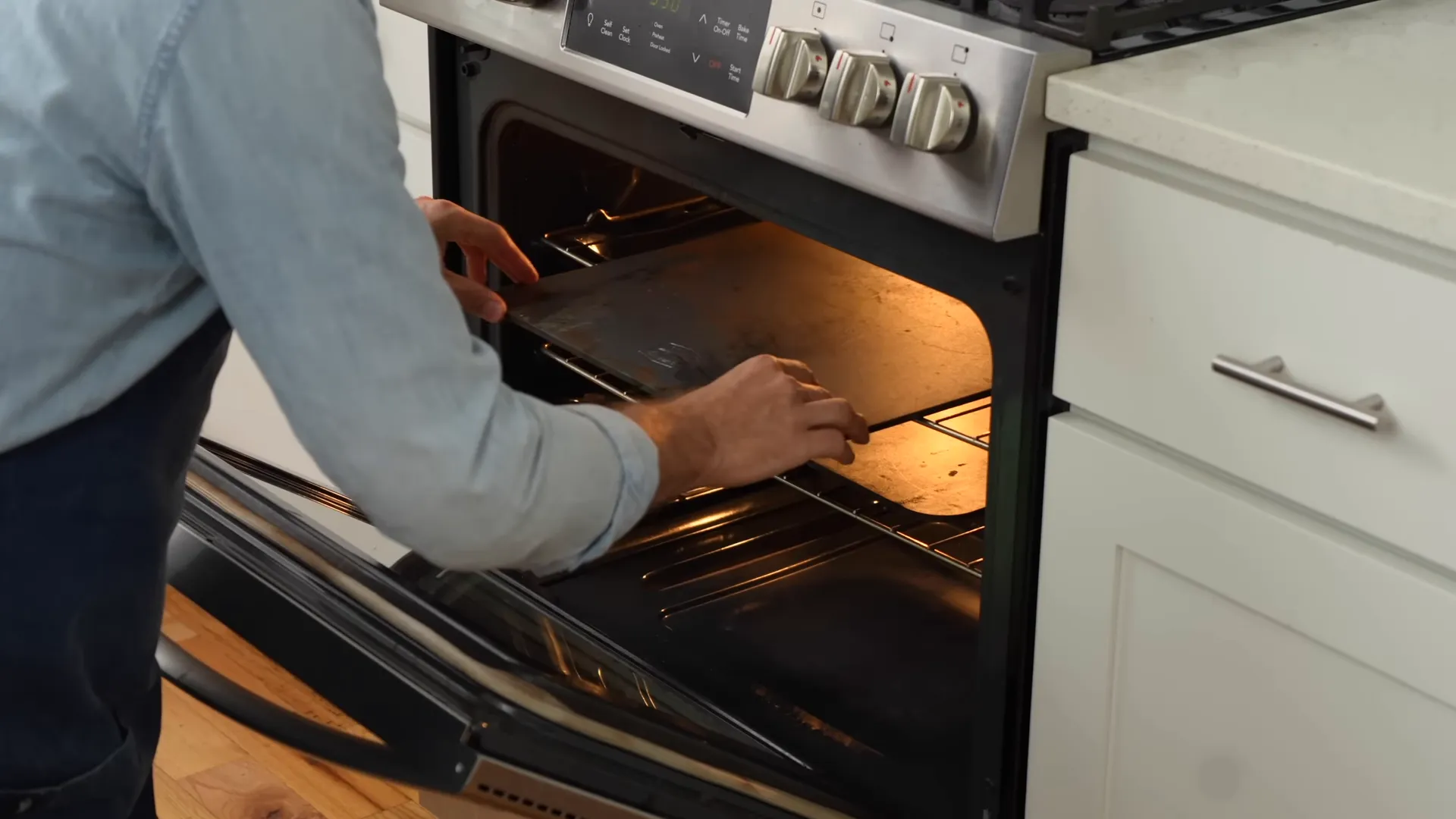 Two pizza steels heating in the oven, one above the other