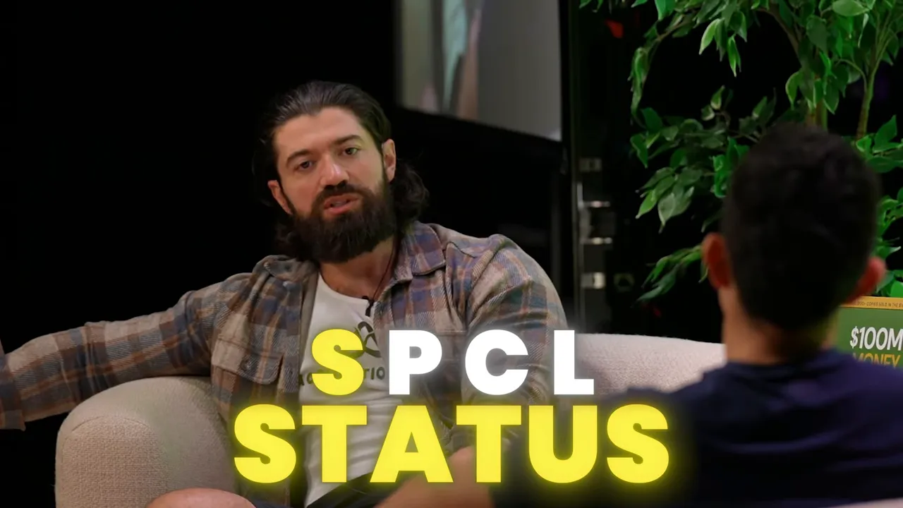 Presenter in a seated interview discussing status with a clear 'SPCL STATUS' title overlay and a guest visible in the foreground.