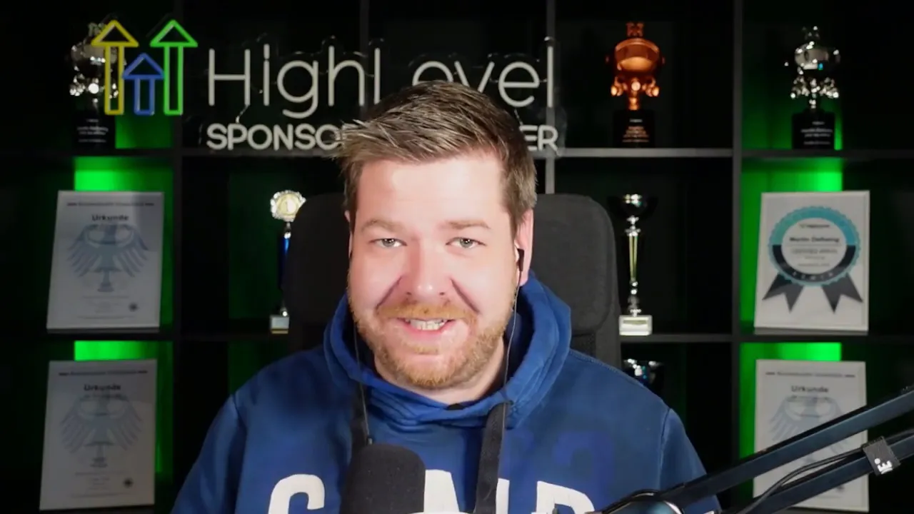 presenter smiling and speaking in a well-lit studio with awards in the background while explaining tool consolidation