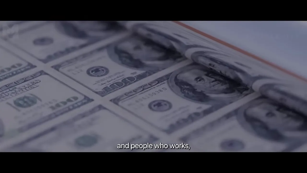 Close-up of sheets of $100 bills on a printing press with subtitle at bottom