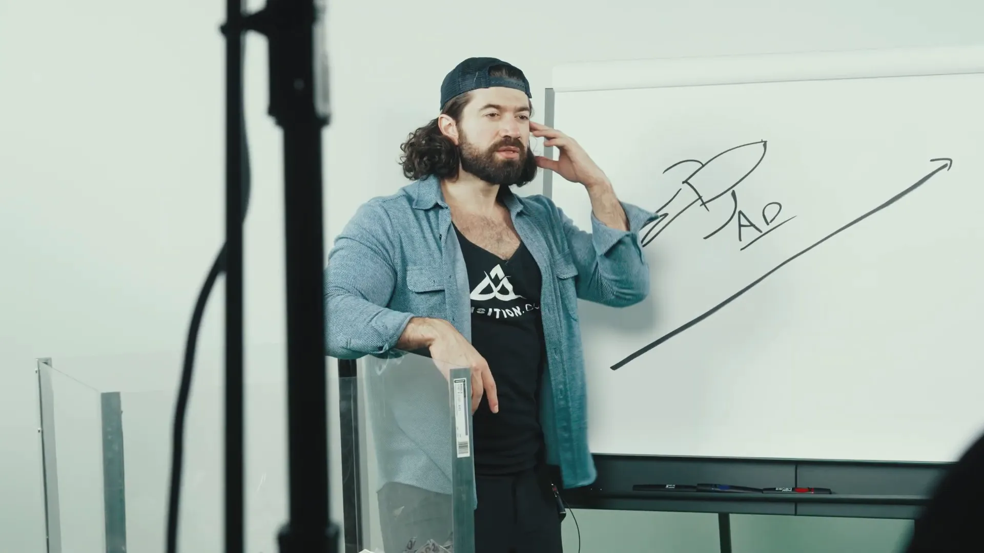 Alex speaking to camera about monetary strategy and launch scale