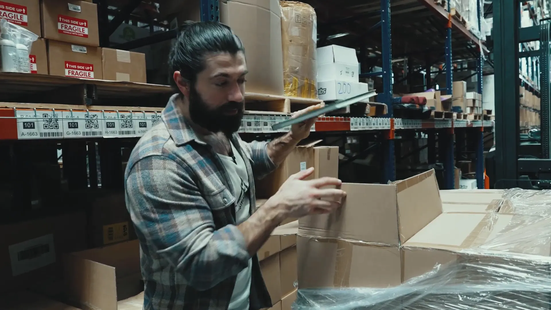 Boxes being opened and books pre-kitted in warehouse