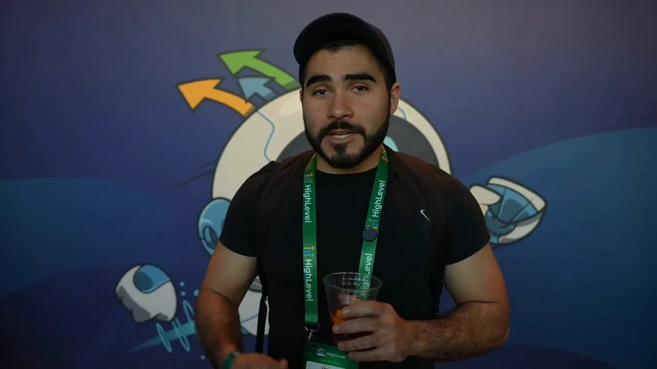 close-up of a speaker at a marketing event with branded lanyard against a blue backdrop