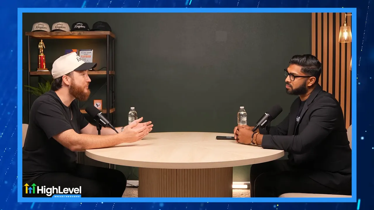 Two hosts facing each other across a table in a podcast interview