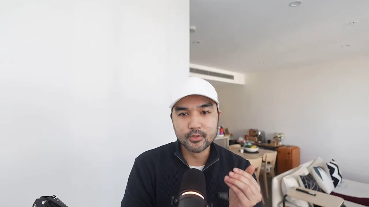 Frontal shot of presenter speaking into a microphone with hands visible, illustrating n8n workflow orchestration within GFunnel