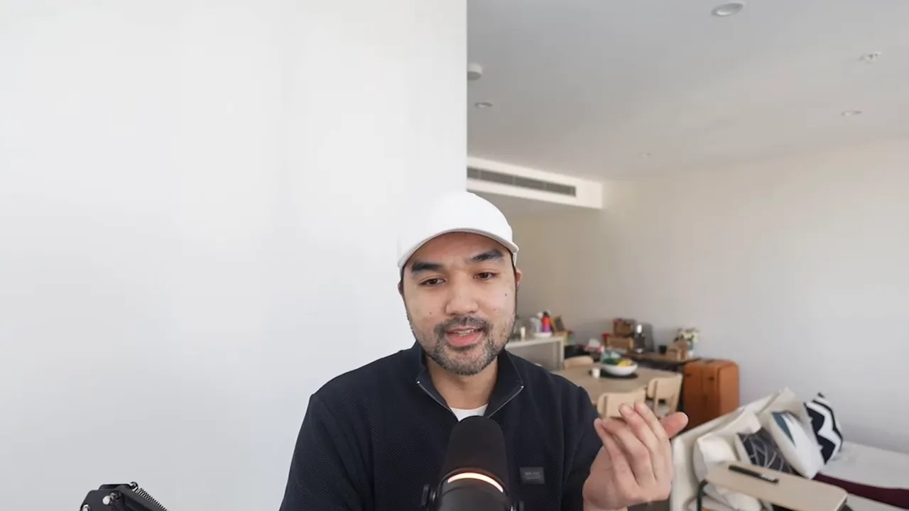 Person speaking and gesturing into a microphone in a home office, demonstrating a workflow