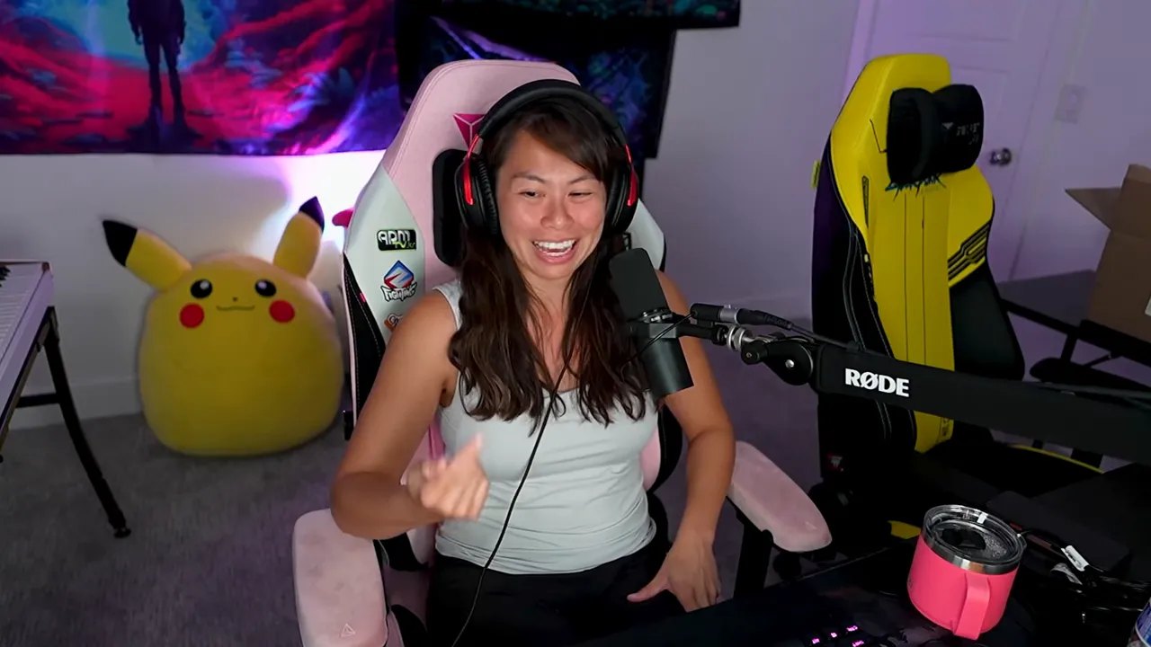 Smiling creator at desk speaking into a microphone with headset and clear studio background