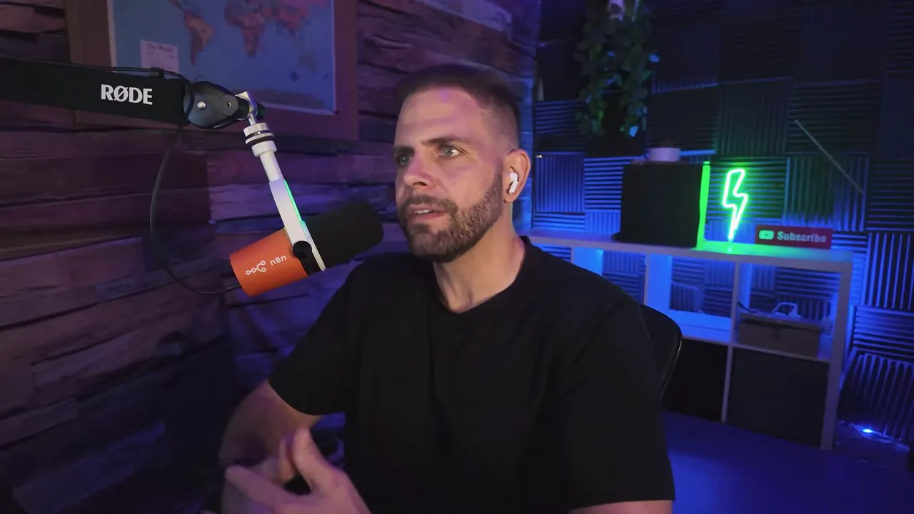 Presenter speaking into studio microphone with an orange n8n-branded mic cover and podcast setup in background