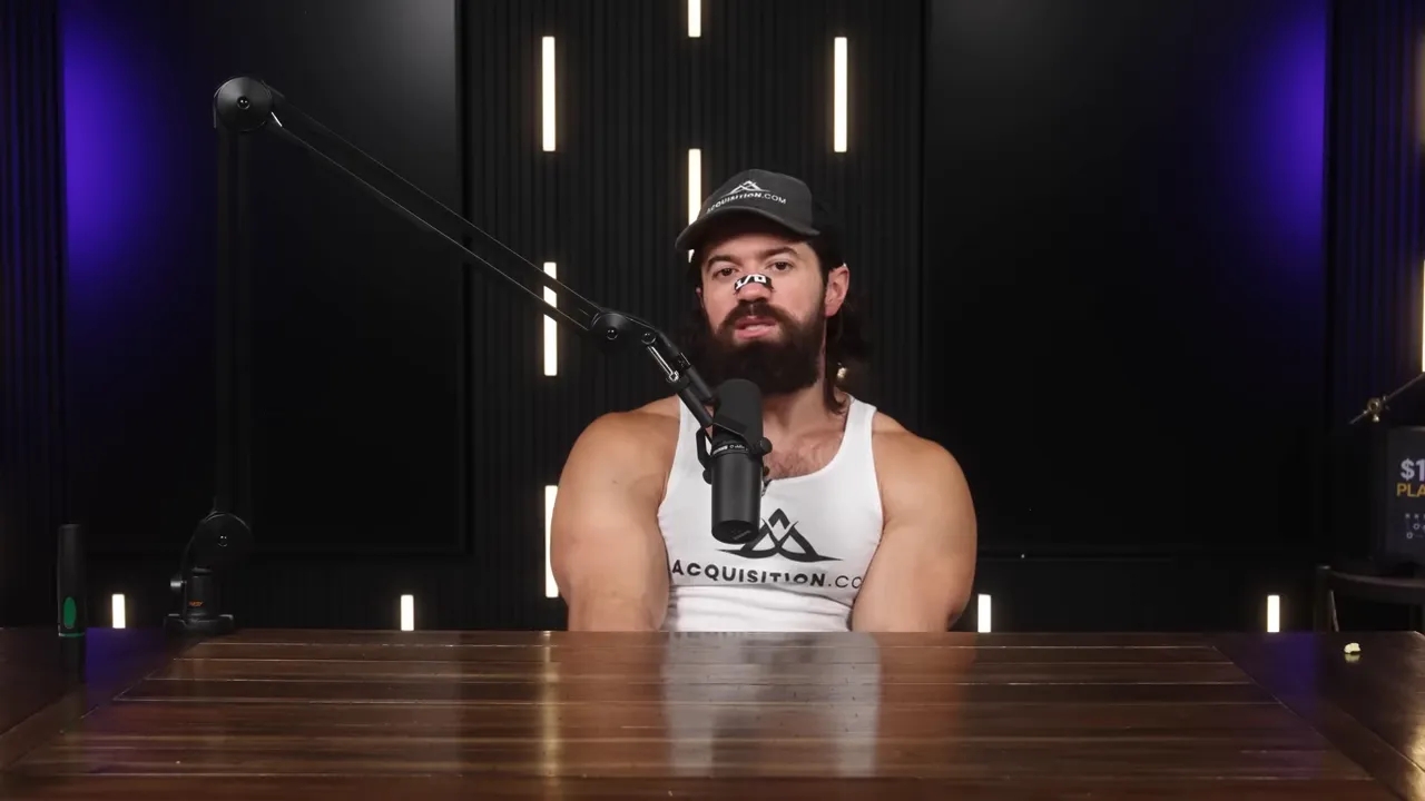 Centered podcast host at a wooden table speaking into a boom microphone with black acoustic panels and purple side lighting