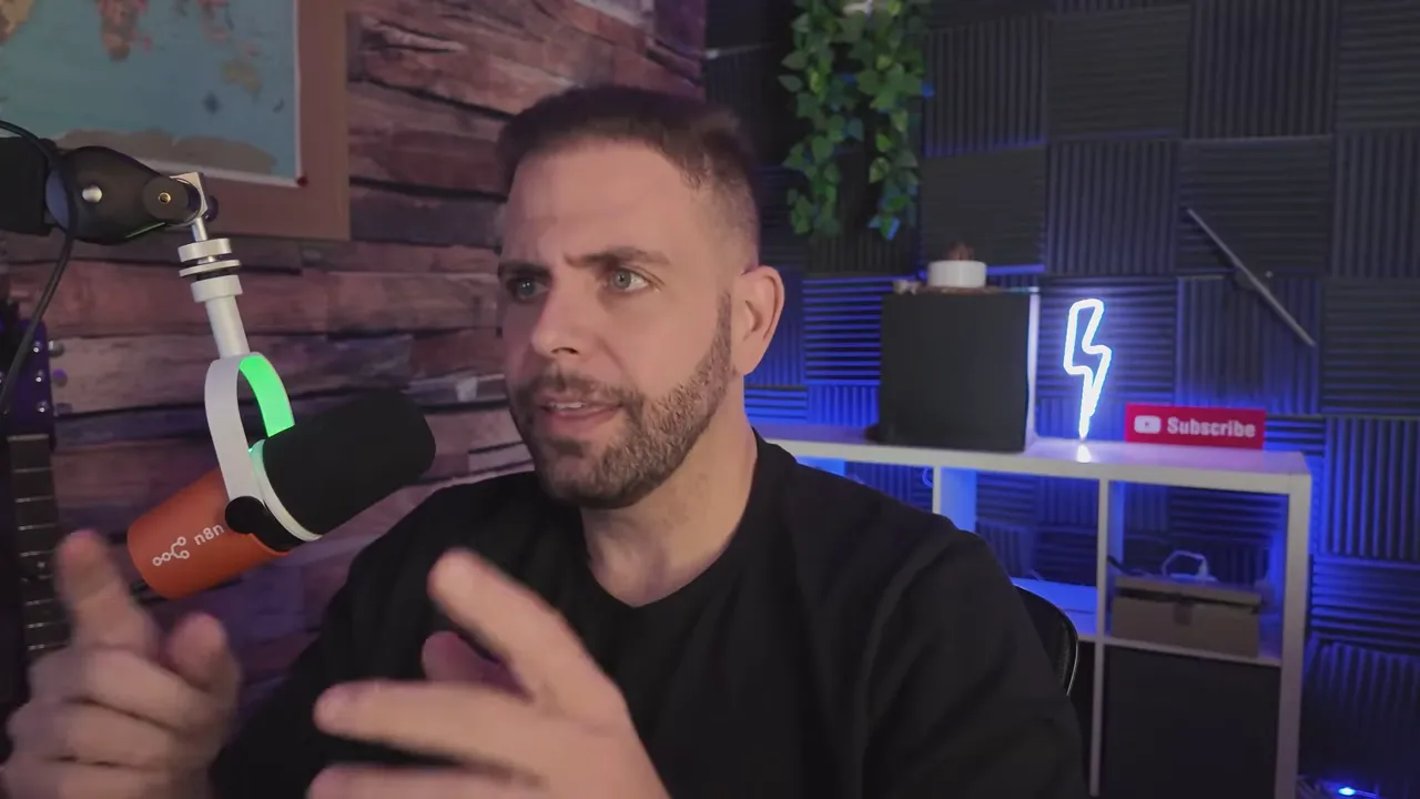 Presenter looking slightly off-camera while gesturing, microphone and studio shelving with neon accent in the background
