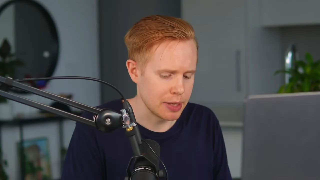 Presenter at desk speaking into a boom microphone with laptop to the right, clearly explaining GFunnel's role