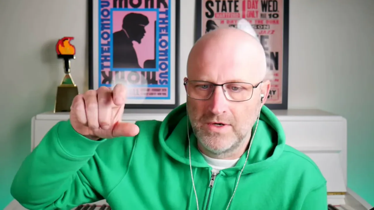 Presenter in green hoodie pinching with fingers to indicate a small, testable prototype in a home office — practical N8N GFunnel workflow example