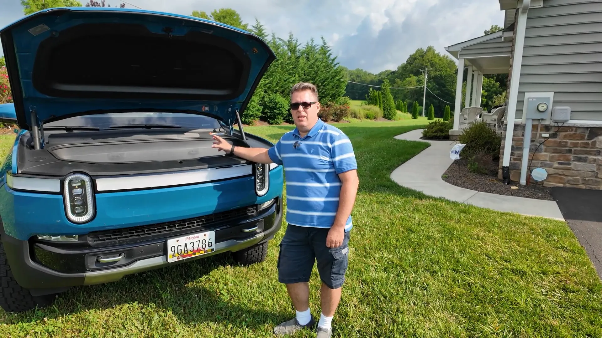 Open front trunk of first generation Rivian showing large frunk space