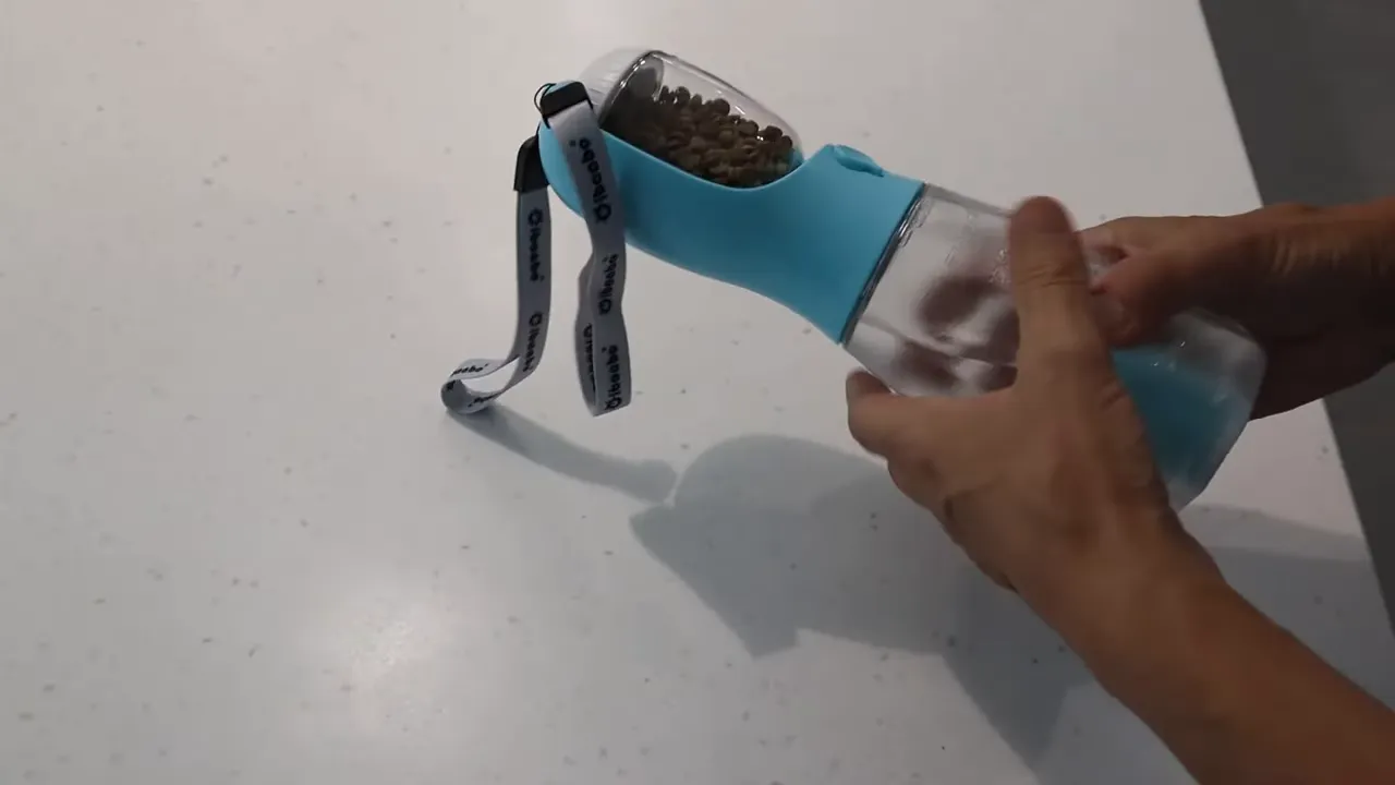 Removable treat container filled with small kibble