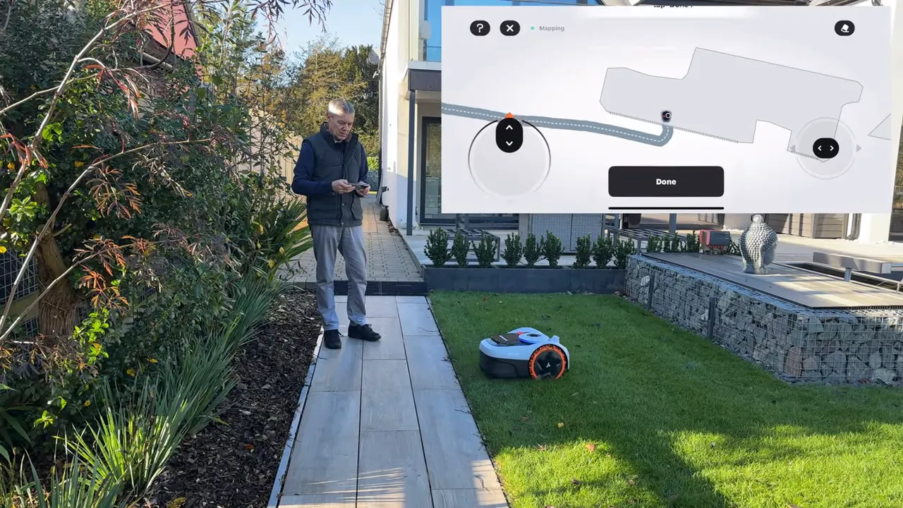 Navimow i105 robotic mower cutting a strip of grass with the app map overlay displaying the planned route