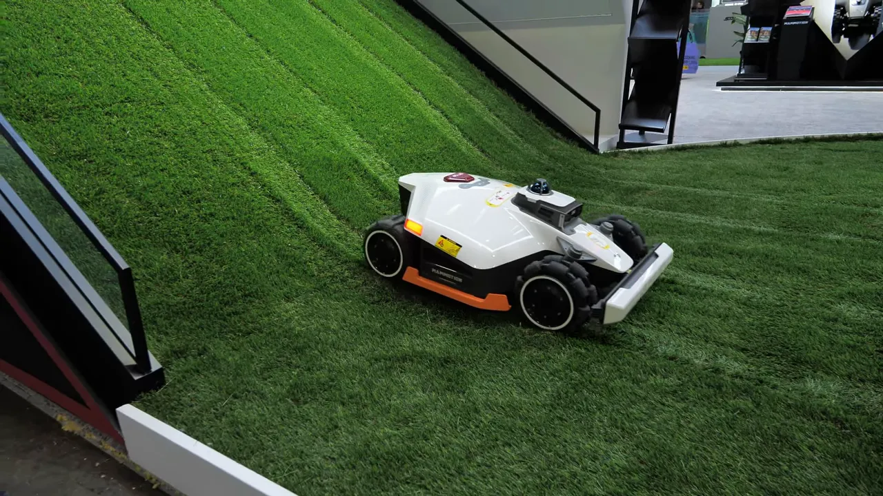 Close-up of Mammotion Luba 3 AWD showing LiDAR dome and four-wheel drive on a steep grass slope