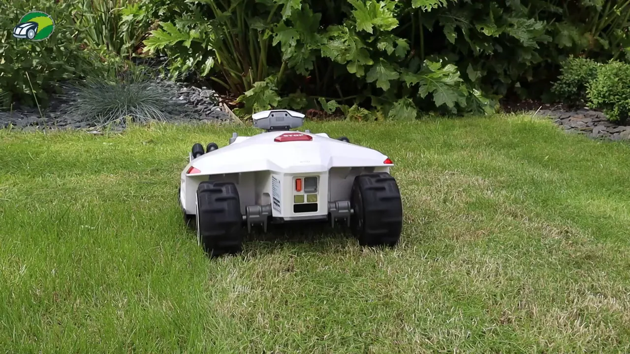 Luba 2 robotic mower rear view showing wheels, sensor module and connectors on grass